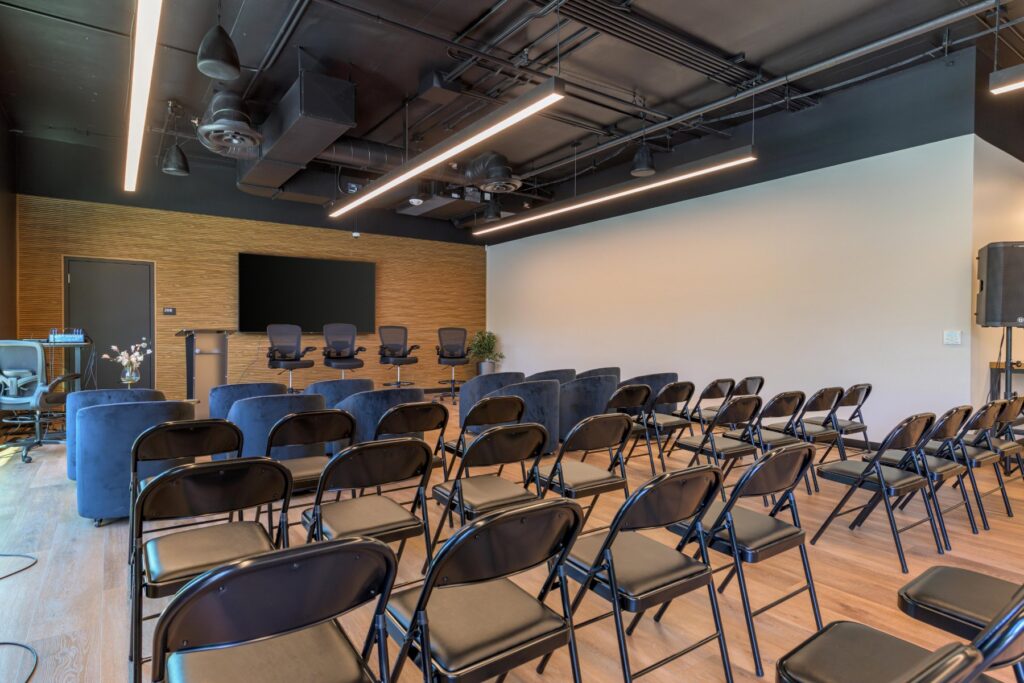 Event seating facing a screen at STAK Space, 1920 Broadway, Oakland