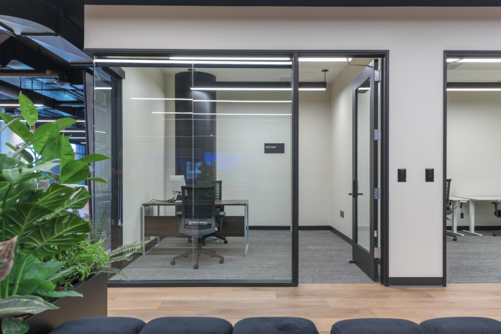 Glass office suite with greenery at STAK Space, 1920 Broadway, Oakland