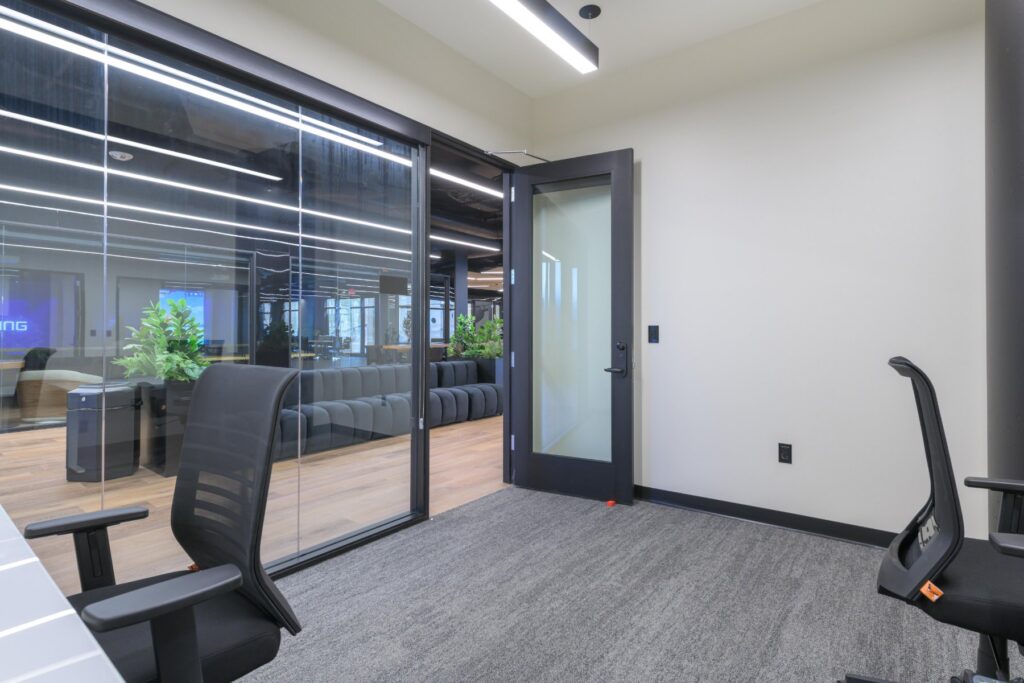 Hallway of glass private offices at STAK Space, 1920 Broadway, Oakland