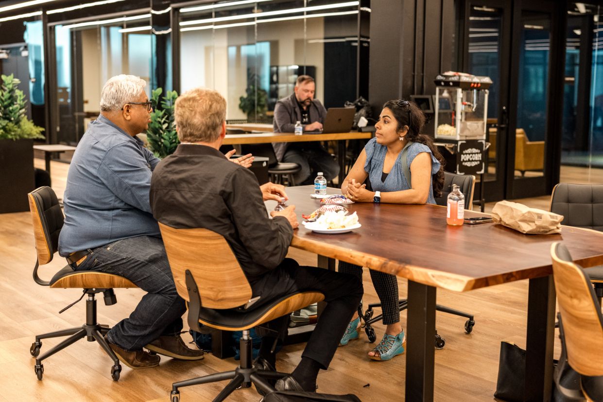 Members working together at a table at STAK